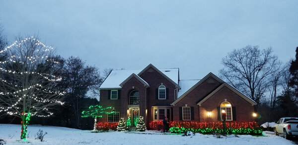 A snow-dusted yard in red, green, and white