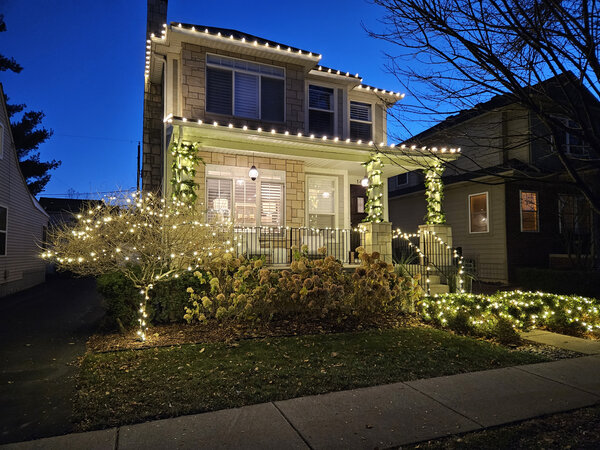 A garland-wrapped porch aglow