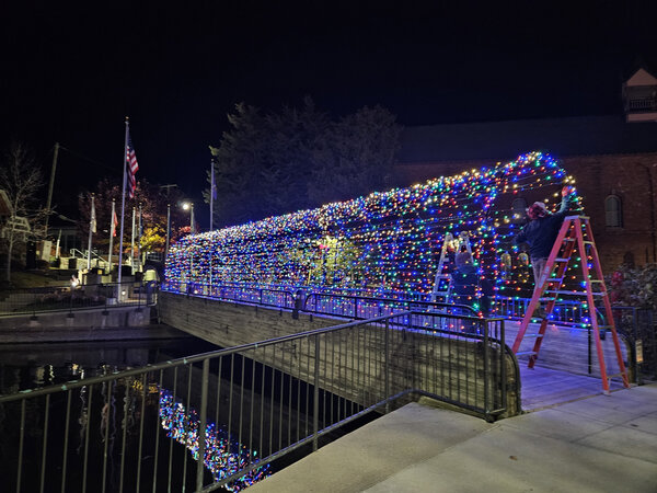 A footbridge cloaked in color, mid-install