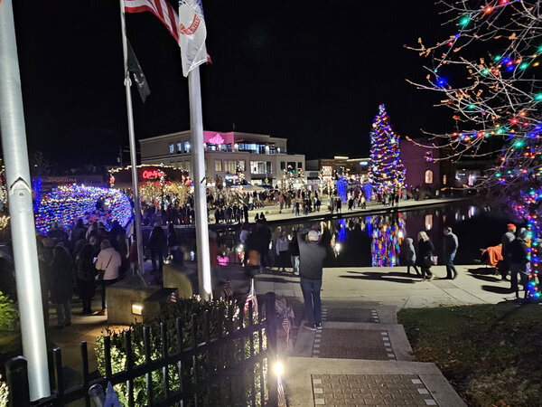 Crowds along the lit waterfront