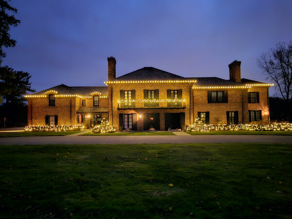 A symmetric facade traced in warm white