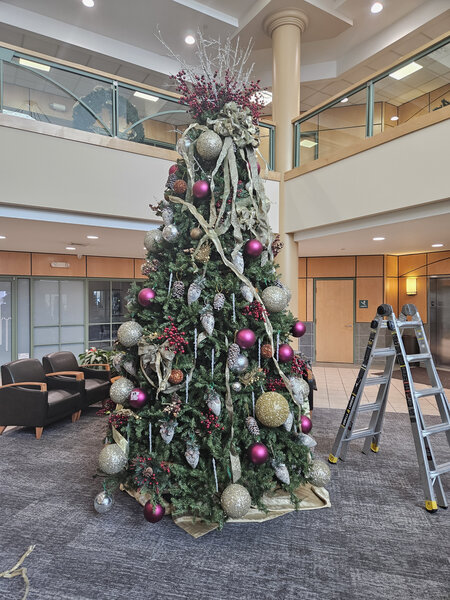 A two-story lobby tree in silver and plum