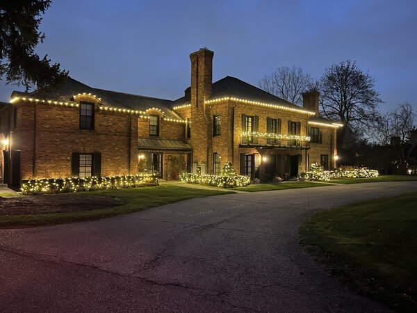 A brick estate outlined at twilight